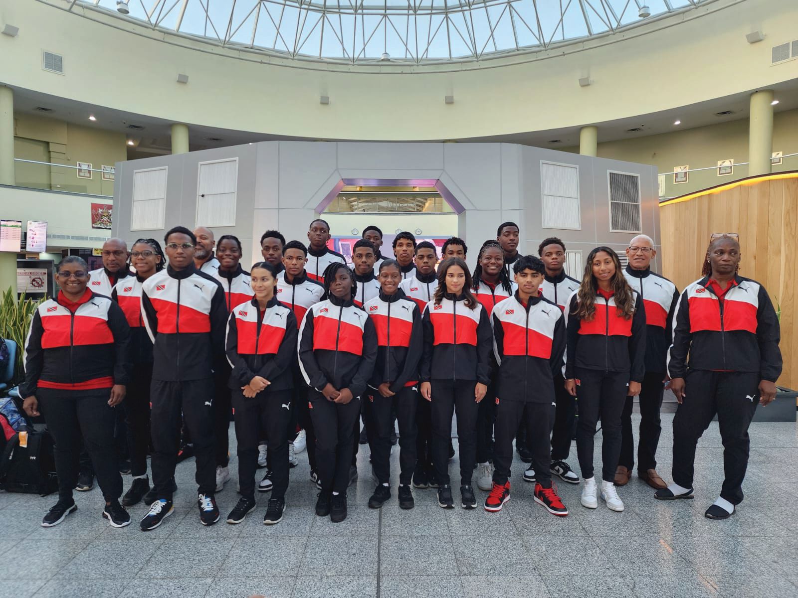 T&T swimmers and officials pose for a team photo prior to their departure from Piarco International Airport for Bahamas via Jamaica to compete at this weekends’ 37th Carifta Swimming Championships at the Betty Kelly- Kenning Aquatic Centre in Nassau, Bahamas from Saturday, March 30 to Tuesday, April 2. PICTURE ASAT&T (Image obtained at guardian.co.tt)