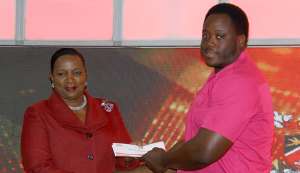 Paralympic champ Akeem Stewart, right, collects his cheque from Minister of Social Development Cherrie-Ann Crichlow-Cockburn. PHOTO BY ROGER JACOB Paralympic champ Akeem Stewart, right, collects his cheque from Minister of Social Development Cherrie-Ann Crichlow-Cockburn. PHOTO BY ROGER JACOB