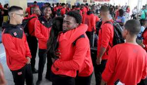 National hockey player Kristien Emmanuel, centre, brother of deceased Kwasi Emmanuel, is consoled by a female player at the Piarco International Airport yesterday. National hockey player Kristien Emmanuel, centre, brother of deceased Kwasi Emmanuel, is consoled by a female player at the Piarco International Airport yesterday.