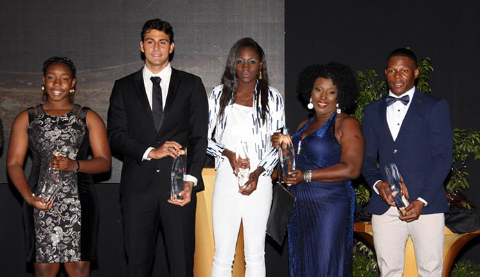 From left, Keona Yorke, sister of swimmer Kael Yorke, swimmer Dylan Carter, Shanique Bascombe, Yvette Wilson, mother of Jereem Richards and Nicholas Paul pose with their awards at the TTOC’s annual Awards, held yesterday at the Hyatt Regency Hotel, Port of Spain.