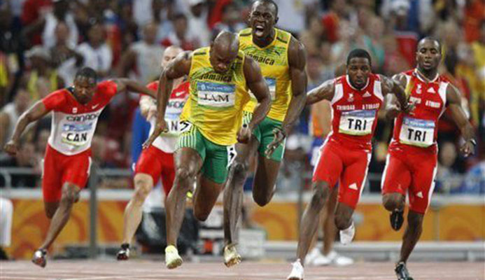 DECISIVE LEG: Trinidad and Tobago’s Richard Thompson, second right, receives the baton from Emmanuel Callendar even as Jamaica’s Usain Bolt, centre right, urges on Asafa Powell who is already into stride, on the final leg of the men’s 4x100-metre relay at the Beijing 2008 Olympics in China on August 22, 2008. Powell crossed the finish line ahead of Thompson but, ten years later, T&T will be given the gold because Jamaica’s first leg runner Nesta Carter was doped.