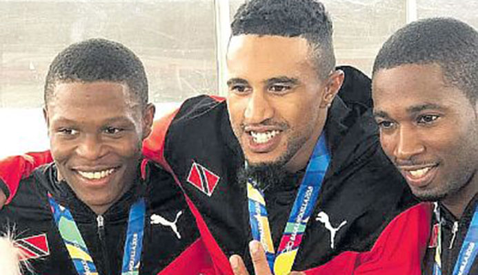T&T men’s cycling sprint team from left, Nicholas Paul, Njisane Phillip and Kwesi Browne sporting their gold medals won during yesterday’s sprint event.
