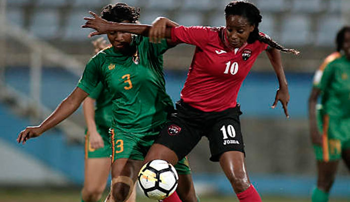 Photo: Trinidad and Tobago captain Tasha St Louis (right) holds off Grenada defender Treasher Valcin during 2019 World Cup qualifying action at the Ato Boldon Stadium on 27 May 2018. (Copyright Annalisa Caruth/Wired868)