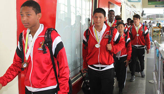 In this file photo, members of the TT water polo boys Under-15 team arrive at the Piarco International Airport, on July 8, after winning gold in CCCAN water polo, in Barbados.