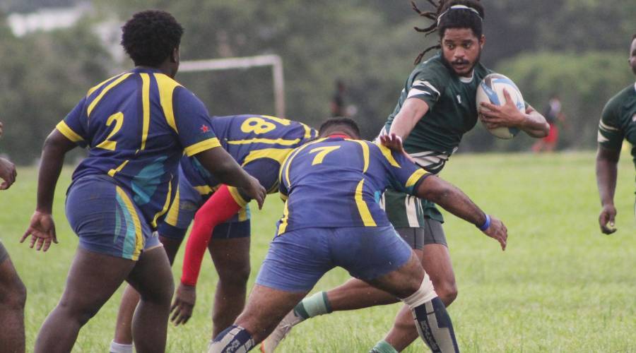 Harvard’s Asan Lewis tries to evade several tackles from Royalians players headed by Akel Welsh during their TTRFU Championship Division League match on Royalians Grounds at the Queen’s Park Savannah, Port-of-Spain, on Saturday. Harvard won 22-15.