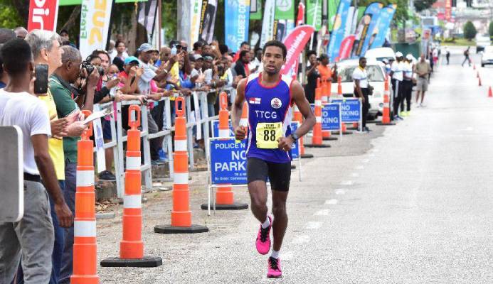 PEREIRA SHINES: Collin Pereira nears the Trinidad and Tobago International Marathon finish line at the Queen’s Park Savannah in Port of Spain, on Sunday. The coast guardsman got home in a personal best two hours, 40 minutes, 49 seconds to secure third spot. Pereira was the first T&T runner to complete the race.   —Photo: JERMAINE CRUICKSHANK