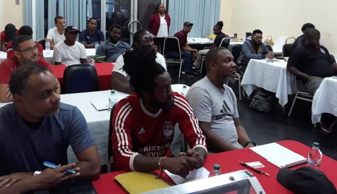 Susan Joseph-Warrick, TTFA Vice-President and WoLF President looks on while the participants listen attentively to Concacaf/Fifa instructor Anton Corneal at the start of the T&T Women’s League Football (TTWoLF) hosted inaugural 'C' License Coaching Course at Ato Boldon Stadium, in Balmain, Couva on Monday.  TTWoLF