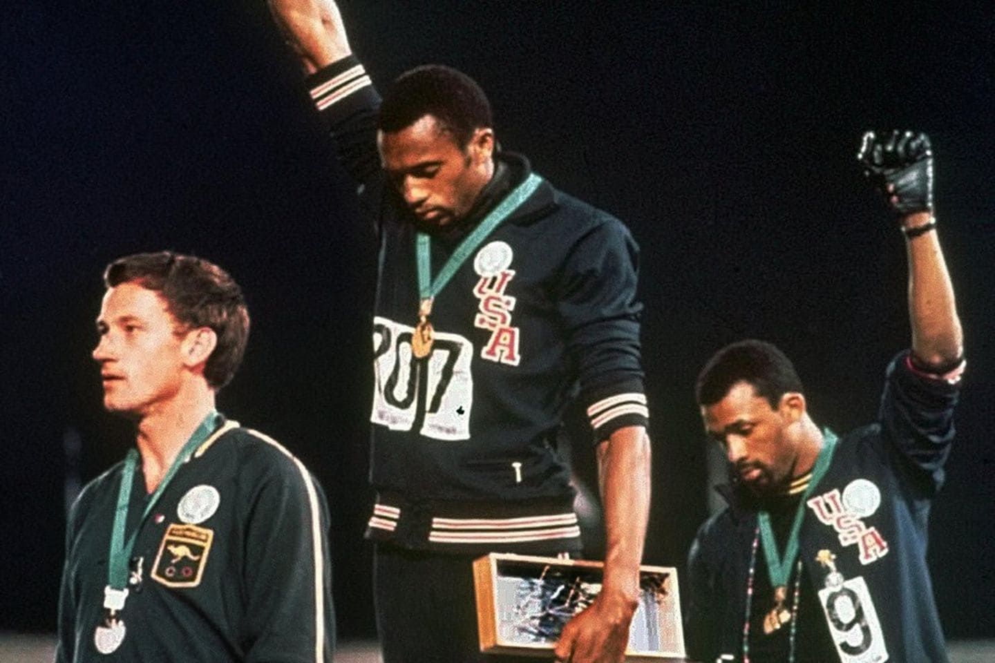 U.S. Olympic gold medallist Tommie Smith, center, and his teammate John Carlos, who won bronze in the 200-meter race, raise their fists during the U.S. national anthem at the 1968 Summer Games in Mexico City. Australian silver medalist Peter Norman is at left. (AP Photo)