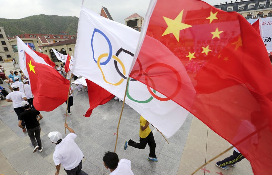 Local residents holding Chinese and Olympic flags attend a rehearsal in Chongli county of Zhangjiakou ahead of the 2008 Olympic Games in Beijing. Reuters/Jason Lee