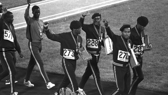 Vince Matthews (288) was one of three members of the U.S. 4x400-meter relay team that held up clenched fists after receiving their gold medals in the Mexico City Games in 1968. AP Photo/File (Image obtained via ESPN.com)
