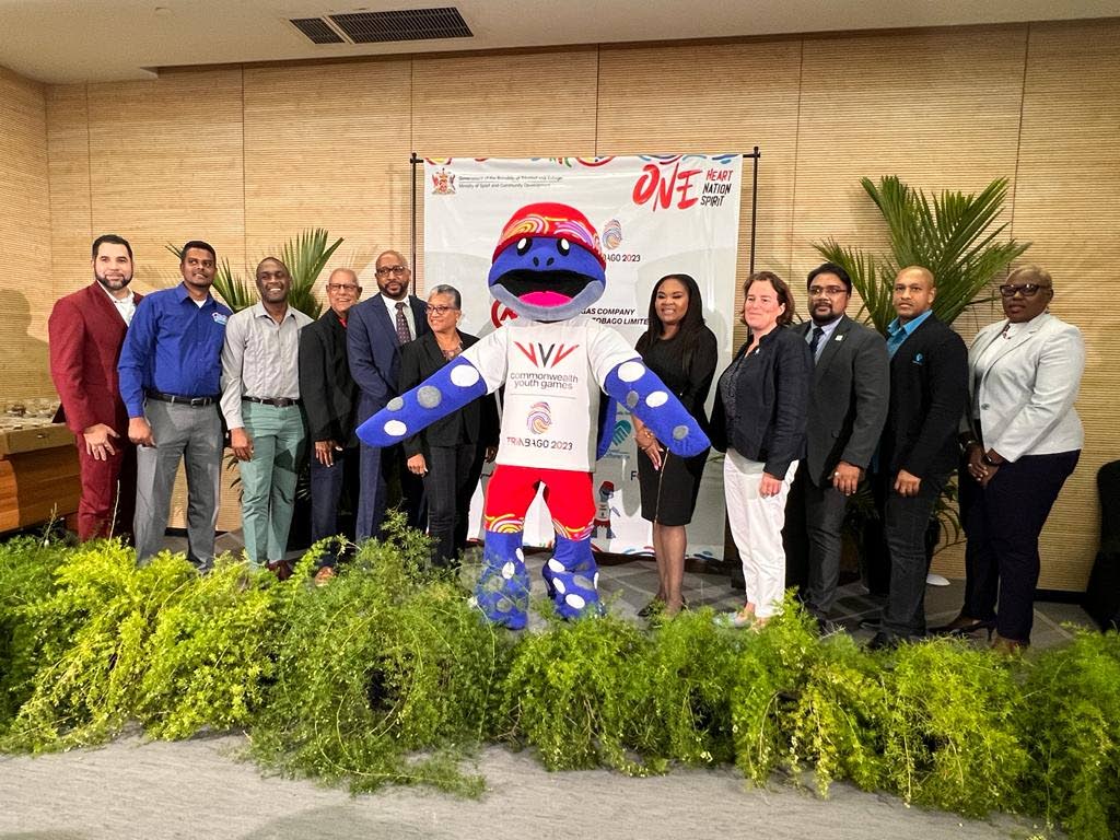 From left, Guardian Life's Gregg Mannette, Blue Waters' Avinash Lallo, Lanher CEO Sean Roach, local organising committee chairman Douglas Camacho; NGC's Myles Lewis; TTCGA chairman Diane Henderson; Games mascot Cocoyea, Sport Minister Shamfa Cudjoe; Commonwealth Games Federations' Annie Hairsine; Proman's Fazad Mohammed; Republic Bank's Sherwin Forte and Tourism Trinidad CEO Carla Cupid. - Courtesy CYG committee (Image obtained at newsday.co.tt)