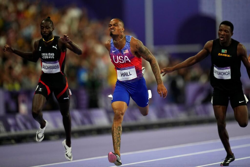 Trinidad and Tobago sprinter Jereem Richards, left, finishes a national record-breaking run in the finals of the 400-metre sprint in fourth position at the 2024 Summer Olympics in Paris France on August 7, 2024. Also in photo are gold-medal winner Quincy Hall of the US, centre, and bronze-medal winner Muzala Samukonga of Zambia. England’s Matthew Hudson-Smith took home the silver medal. - AP PHOTO (Image obtained at newsday.co.tt)