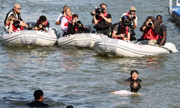 Photographers capture Anne Hidalgo’s swim in the Seine on Wednesday. Photograph: Xinhua/Rex/Shutterstock (Image obtained at theguardian.com)