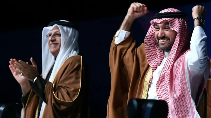 Asian Football Confederation president Sheikh Salman bin Ibrahim al-Khalifa and Saudi Arabia's minister of sports and youth Abdulaziz bin Turki Al Faisal celebrate the announcement (GETTY IMAGES) (Image obtained at bbc.com)