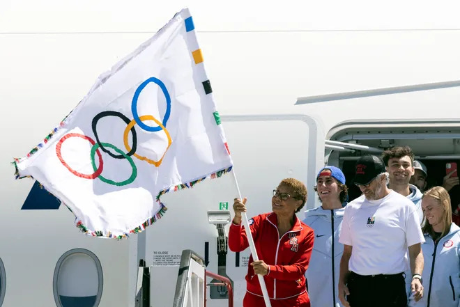 Los Angeles mayor Karen Bass waves the Olympic flag next to LA28 chairman Casey Wasserman after their plane landed during the event celebrating the arrival of the Olympic flag at Los Angeles International Airport (LAX) on Aug. 12. ETIENNE LAURENT, AFP Via Getty Images (Image obtained at usatoday.com)