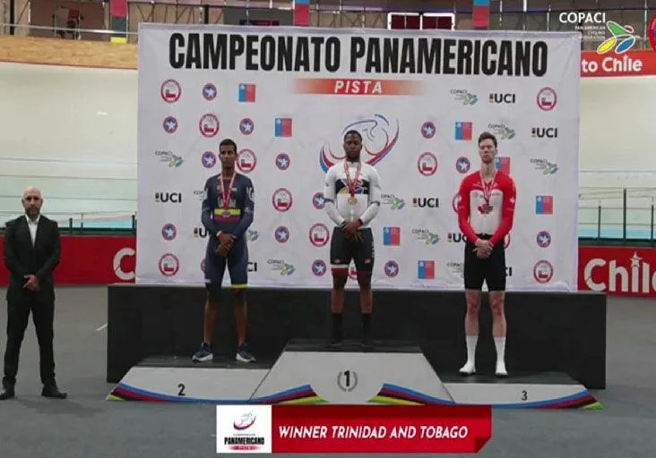 KEIRIN CHAMP: Winner Nicholas Paul of Trinidad and Tobago, centre, stands atop the rostrum, flanked by silver medallist Kevin Quintero of Colombia, left, and bronze  medallist Nick Wammes of Canada, during the medal ceremony for the keirin event at the Elite Pan American Track Cycling Championships in Santiago, Chile, yesterday.  —Photo courtesy Trinidad and Tobago Cycling Federation (Image obtained at trinidadexpress.com)