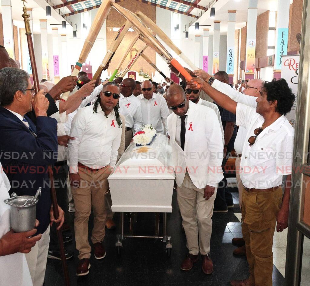 Bats are raised in a guard of honour as pallbearers carry the casket following the funeral for former West Indies and TT cricketer Bernard Julien, on October 18, at St Finbar’s RC Church, Diego Martin. - Photos by Faith Ayoung (Image obtained at newsday.co.tt)