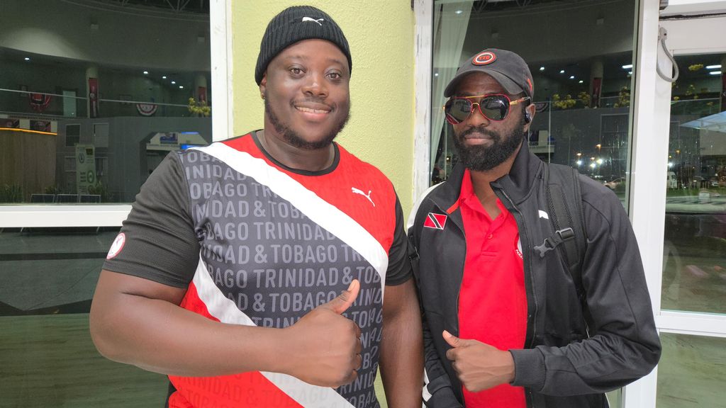 Akeem Stewart, left, with physiotherapist Mickey Reuben at the Piarco International Airport on September 28 as he left for the 2025 World Para Athletic Championships in New Delhi, India. Stewart will compete in the men's discus throw F 44 finals on Saturday.  Clayton Clarke (Image obtained at guardian.co.tt)